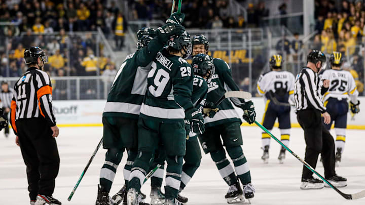 Michigan State players celebrate a goal scored by center Red Savage against Michigan during the third period at Yost Ice Arena in Ann Arbor on Friday, Feb. 9, 2024. Michigan State players celebrate a goal scored by center Red Savage against Michigan during the third period at Yost Ice Arena in Ann Arbor on Friday, Feb. 9, 2024.