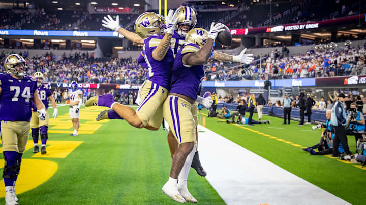 Dezmen Roebuck, Denzel Boston and Jonah Coleman celebrate an LA Bowl touchdown. 