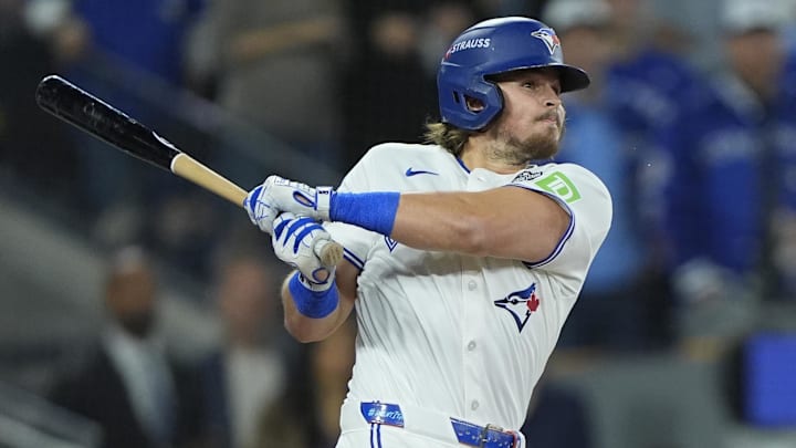 Toronto Blue Jays third baseman Addison Barger hits a single with a bat Toronto Blue Jays third baseman Addison Barger hits a single with a bat