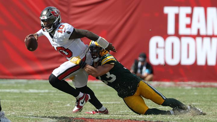 Oct 4, 2026; Tampa, Florida, USA;  Green Bay Packers safety Evan Williams (33) tackles Tampa Bay Buccaneers quarterback Jalon Daniels (10) during the fourth quarter at Raymond James Stadium.  Mandatory Credit: Matt Pendleton-Imagn Images