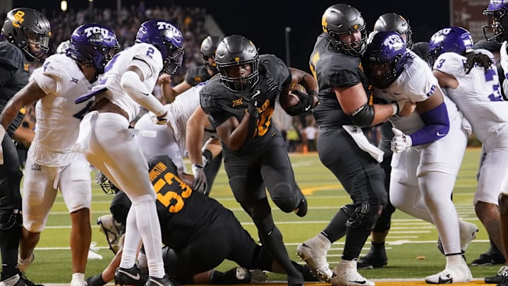 Nov 2, 2024; Waco, Texas, USA; Baylor Bears running back Bryson Washington (30) scores his fourth touchdown against the TCU Horned Frogs during the second half at McLane Stadium. Mandatory Credit: Chris Jones-Imagn Images