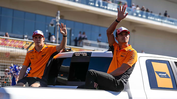 Oct 20, 2024; Austin, Texas, USA; McLaren Racing drivers Lando Norris and Oscar Piastri wave to the crowd during the drivers' parade at the Formula 1 Pirelli United States Grand Prix at Circuit of the Americas. Mandatory Credit: Aaron E. Martinez-Imagn Images