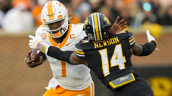 Nov 11, 2023; Columbia, Missouri, USA; Tennessee Volunteers quarterback Joe Milton III (7) stiff arms Missouri Tigers linebacker Triston Newson (14) during the first half at Faurot Field at Memorial Stadium. Mandatory Credit: Jay Biggerstaff-Imagn Images Nov 11, 2023; Columbia, Missouri, USA; Tennessee Volunteers quarterback Joe Milton III (7) stiff arms Missouri Tigers linebacker Triston Newson (14) during the first half at Faurot Field at Memorial Stadium. Mandatory Credit: Jay Biggerstaff-Imagn Images