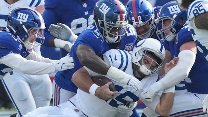 Dec 29, 2024; East Rutherford, New Jersey, USA; Indianapolis Colts quarterback Joe Flacco (15) is stopped by the Giants defense during the first quarter at MetLife Stadium. Mandatory Credit: Robert Deutsch-Imagn Images