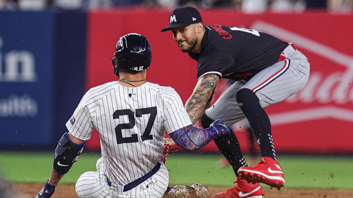 Jun 5, 2024; Bronx, New York, USA; New York Yankees designated hitter Giancarlo Stanton (27) is tagged out by Minnesota Twins shortstop Carlos Correa (4) at second base during the fifth inning at Yankee Stadium. Mandatory Credit: Vincent Carchietta-Imagn Images