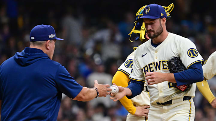 Milwaukee Brewers manager Pat Murphy makes a trip to the mound to pull relief pitcher Aaron Ashby.