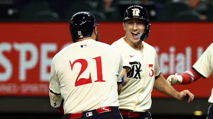 Texas Rangers first baseman Jake Burger (21) celebrates with Texas Rangers left fielder Wyatt Langford (36) after hitting a two-run home run during the third inning against the Houston Astros at Globe Life Field.