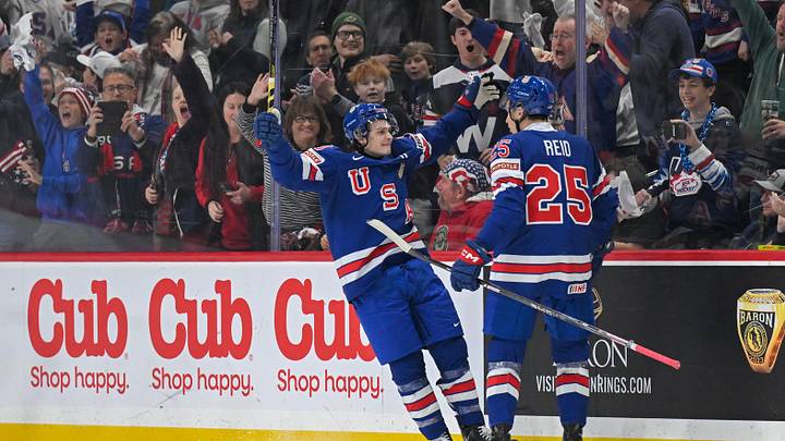 Dec 31, 2025; St. Paul, Minnesota, USA; USA defensemen Chase Reid (25) celebrates his power play goal against Sweden with forward James Hagens (10) during the second period in group play during the 2026 IIHF World Junior Championship at Grand Casino Arena. Mandatory Credit: Nick Wosika-Imagn Images