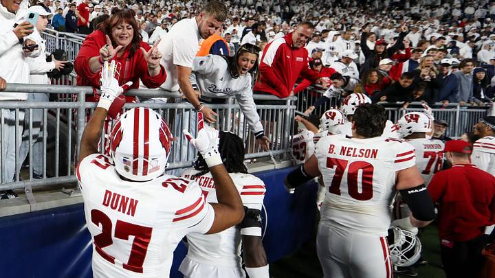 Wisconsin Badgers players celebrate with the fans following the game against the Penn State Nittany Lions. Wisconsin Badgers players celebrate with the fans following the game against the Penn State Nittany Lions.