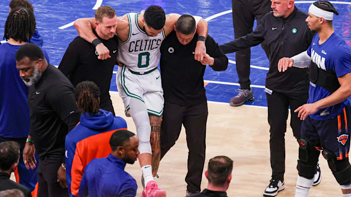 Boston Celtics forward Jayson Tatum (0) is helped off the court by after an injury in the second half during game four of the second round for the 2025 NBA Playoffs.