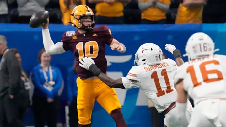 Arizona State quarterback Sam Leavitt (10) throws under pressure by Texas linebacker Colin Simmons (11) during the first quarter of the Chick-fil-A Peach Bowl in Atlanta on Wednesday, Jan. 1, 2025.