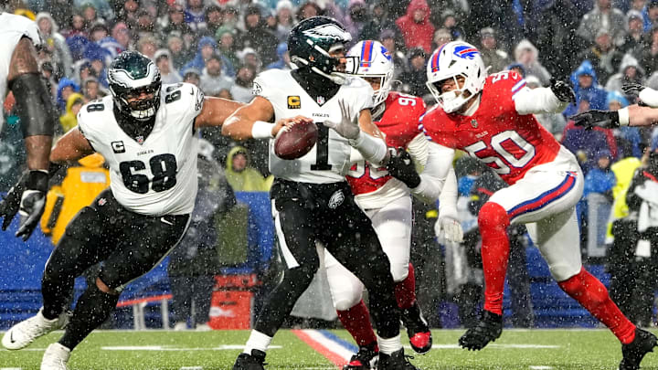 Dec 28, 2025; Orchard Park, New York, USA; Philadelphia Eagles quarterback Jalen Hurts (1) prepares to throw a pass against Buffalo Bills defensive end Greg Rousseau (50) during the first quarter at Highmark Stadium. Mandatory Credit: Gregory Fisher-Imagn Images