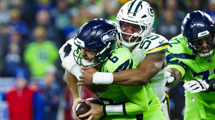 Dec 15, 2024; Seattle, Washington, USA; Green Bay Packers defensive end Kingsley Enagbare (55) sacks Seattle Seahawks quarterback Sam Howell (6) during the third quarter at Lumen Field.