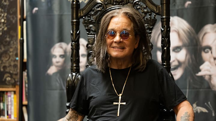 Ozzy Osbourne signs copies of an album