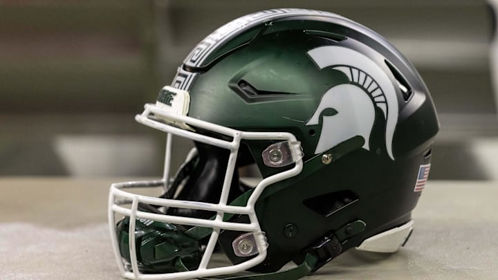 Nov 24, 2023; Detroit, Michigan, USA; A Michigan State Spartans helmet sits on a bench during the second half game against the Penn State Nittany Lions at Ford Field. Mandatory Credit: David Reginek-Imagn Images