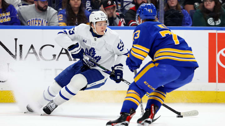 Mar 14, 2026; Buffalo, New York, USA;  Toronto Maple Leafs right wing Easton Cowan (53) skates with the puck as Buffalo Sabres center Ryan McLeod (71) defends the puck during the third period at KeyBank Center. Mandatory Credit: Timothy T. Ludwig-Imagn Images