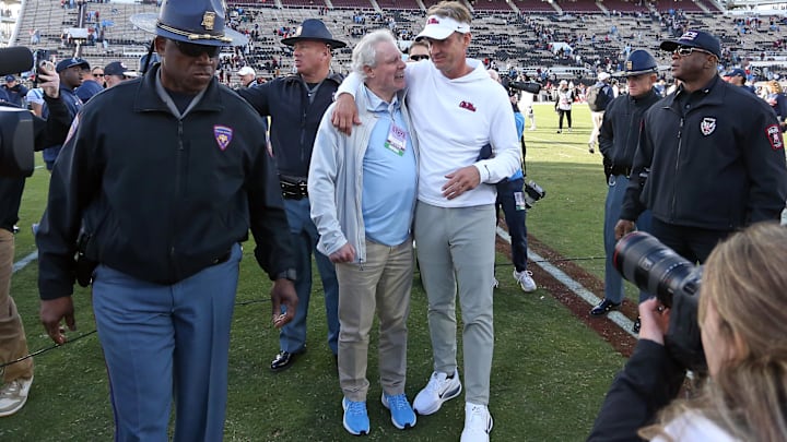 Nov 28, 2025; Starkville, Mississippi, USA; Mississippi Rebels head coach Lane Kiffin embraces chancellor Glenn Boyce after defeating the Mississippi State Bulldogs at Davis Wade Stadium at Scott Field. Mandatory Credit: Petre Thomas-Imagn Images