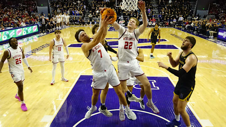 Feb 1, 2025; Evanston, Illinois, USA; Wisconsin Badgers forward Carter Gilmore (7) and forward Steven Crowl (22) grab a rebound against the Northwestern Wildcats during the second half at Welsh-Ryan Arena. Mandatory Credit: David Banks-Imagn Images