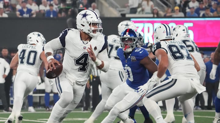 Dallas Cowboys quarterback Dak Prescott rolls out against the New York Giants in the first quarter at MetLife Stadium. Dallas Cowboys quarterback Dak Prescott rolls out against the New York Giants in the first quarter at MetLife Stadium.