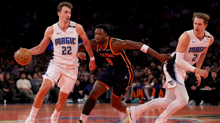 Dec 3, 2024; New York, New York, USA; Orlando Magic forward Franz Wagner (22) controls the ball against New York Knicks forward OG Anunoby (8) in front of Magic center Moritz Wagner (21) during the first quarter at Madison Square Garden. Mandatory Credit: Brad Penner-Imagn Images