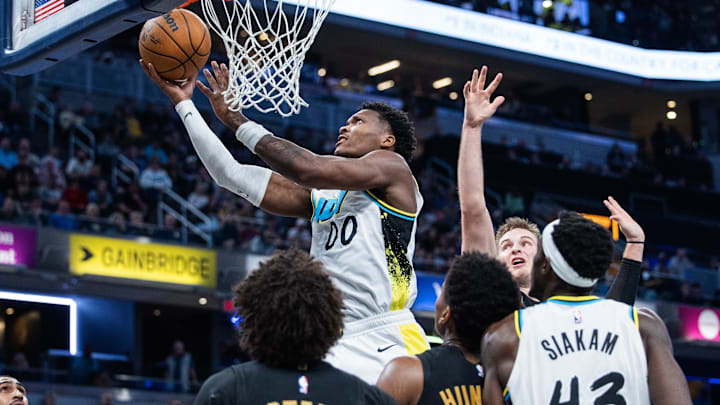 Apr 10, 2025; Indianapolis, Indiana, USA; Indiana Pacers guard Bennedict Mathurin (00) shoots the ball while Cleveland Cavaliers guard Craig Porter Jr. (9) defends in the second half at Gainbridge Fieldhouse. Mandatory Credit: Trevor Ruszkowski-Imagn Images