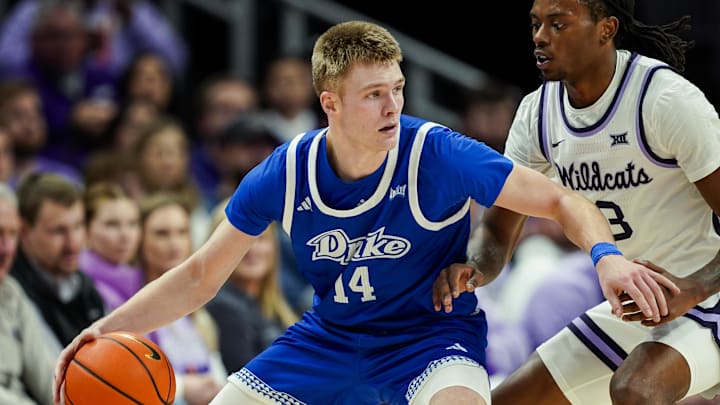 Dec 17, 2024; Kansas City, Missouri, USA; Drake Bulldogs guard Bennett Stirtz (14) dribbles the ball against Kansas State Wildcats guard C.J. Jones (3) at T-Mobile Center. Mandatory Credit: Jay Biggerstaff-Imagn Images