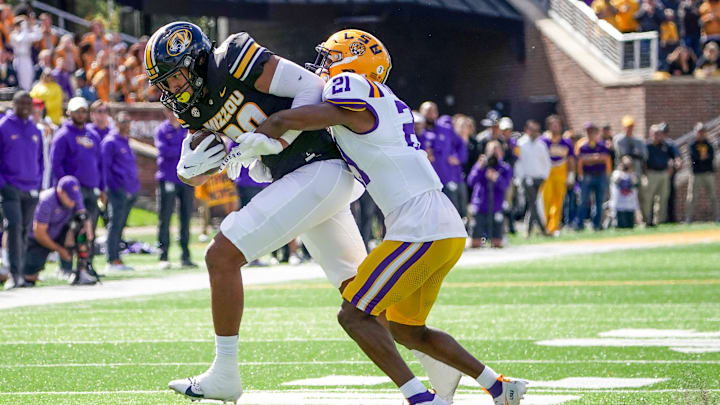 Oct 7, 2023; Columbia, Missouri, USA; Missouri Tigers tight end Tyler Stephens (80) catches a pass as LSU Tigers safety Ryan Yaites (21) defends during the first half at Faurot Field at Memorial Stadium. Mandatory Credit: Denny Medley-Imagn Images