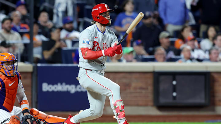 Oct 8, 2024; New York City, New York, USA; Philadelphia Phillies first baseman Bryce Harper (3) hits an RBI single in the eighth inning against the New York Mets during game three of the NLDS for the 2024 MLB Playoffs at Citi Field.