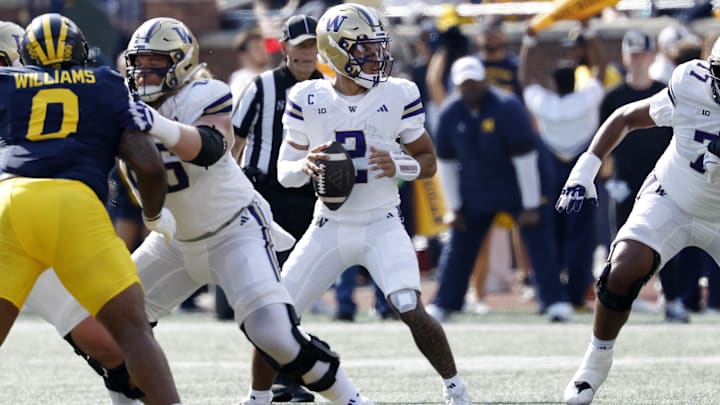 Demond Williams Jr. looks for a Husky receiver while protected by Landen Hatchett (66) and Max McCree (77). Demond Williams Jr. looks for a Husky receiver while protected by Landen Hatchett (66) and Max McCree (77).