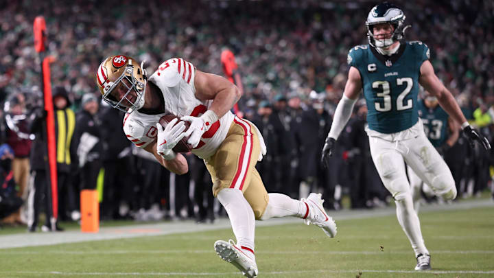 Jan 11, 2026; Philadelphia, PA, USA; San Francisco 49ers running back Christian McCaffrey (23) makes a catch for a touchdown defended by Philadelphia Eagles safety Reed Blankenship (32) during the fourth quarter in an NFC Wild Card Round game at Lincoln Financial Field. Mandatory Credit: Bill Streicher-Imagn Images
