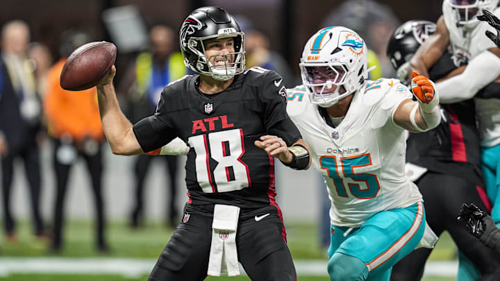 Atlanta Falcons quarterback Kirk Cousins (18) passes under pressure from Miami Dolphins linebacker Jaelan Phillips (15) during the first quarter at Mercedes-Benz Stadium. Atlanta Falcons quarterback Kirk Cousins (18) passes under pressure from Miami Dolphins linebacker Jaelan Phillips (15) during the first quarter at Mercedes-Benz Stadium.
