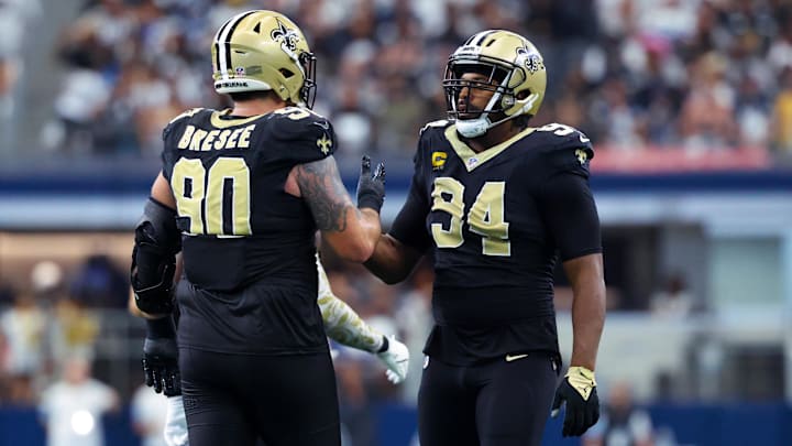 Sep 15, 2024; Arlington, Texas, USA; New Orleans Saints defensive end Cameron Jordan (94) celebrates with New Orleans Saints defensive tackle Bryan Bresee (90) during the second half against the Dallas Cowboys at AT&T Stadium. Mandatory Credit: Kevin Jairaj-Imagn Images