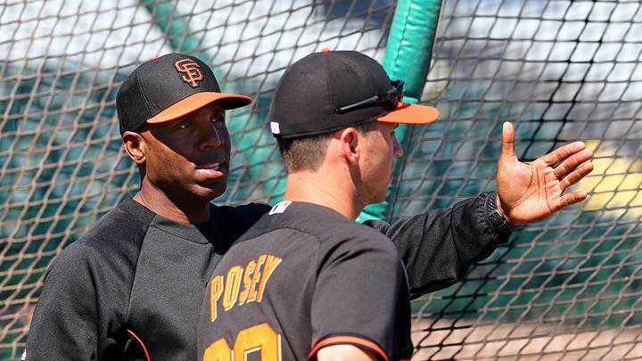 Scottsdale, AZ, USA; San Francisco Giants former outfielder Barry Bonds (left) talks with catcher Buster Posey during batting practice prior to the game against the Chicago Cubs at Scottsdale Stadium. Mandatory Credit: Mark J. Rebilas-USA TODAY Sports