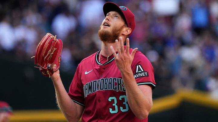 Arizona Diamondbacks left-hander A.J. Puk (33) reacts after closing out their 10-6 win against the Chicago Cubs at Chase Field in Phoenix on Sunday, March 30, 2025.