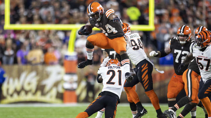 Oct 31, 2022; Cleveland, Ohio, USA; Cleveland Browns running back Nick Chubb (24) leaps over Cincinnati Bengals cornerback Mike Hilton (21) during the second quarter at FirstEnergy Stadium. Mandatory Credit: Scott Galvin-USA TODAY Sports