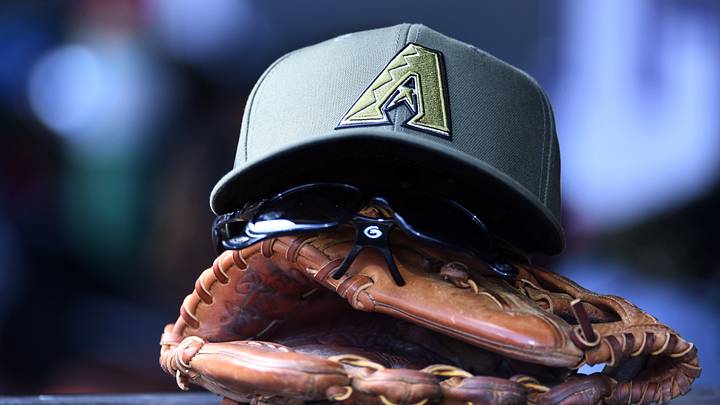 May 16, 2026; Denver, Colorado, USA; View of a Arizona Diamondbacks glove and hat in the dugout against the Colorado Rockies at Coors Field. Mandatory Credit: Christopher Hanewinckel-Imagn Images May 16, 2026; Denver, Colorado, USA; View of a Arizona Diamondbacks glove and hat in the dugout against the Colorado Rockies at Coors Field. Mandatory Credit: Christopher Hanewinckel-Imagn Images