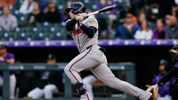 Apr 28, 2025; Denver, Colorado, USA; Atlanta Braves third baseman Austin Riley (27) hits a single in the third inning against the Colorado Rockies at Coors Field.