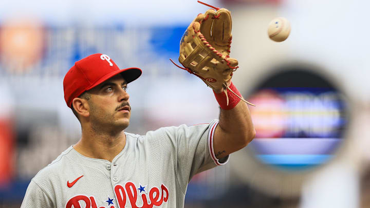 Philadelphia Phillies third baseman Otto Kemp (4) catches a ball as he walks off the field at the end of the third inning in the game against the Cincinnati Reds at Great American Ball Park. 