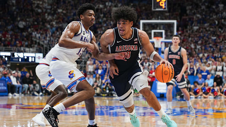 Feb 7, 2026; Lawrence, Kansas, USA; Arizona Wildcats forward Koa Peat (10) drives against Kansas Jayhawks forward Bryson Tiller (15) during the first half at Allen Fieldhouse. Mandatory Credit: Jay Biggerstaff-Imagn Images Feb 7, 2026; Lawrence, Kansas, USA; Arizona Wildcats forward Koa Peat (10) drives against Kansas Jayhawks forward Bryson Tiller (15) during the first half at Allen Fieldhouse. Mandatory Credit: Jay Biggerstaff-Imagn Images