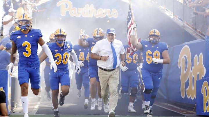 Sep 21, 2024; Pittsburgh, Pennsylvania, USA;  Pittsburgh Panthers defensive back Donovan McMillon (3) and linebacker Brandon George (30) and head coach Pat Narduzzi (tie) and offensive lineman Matt Metrosky (69) take the field to play the Youngstown State Penguins against at Acrisure Stadium. Mandatory Credit: Charles LeClaire-Imagn Images