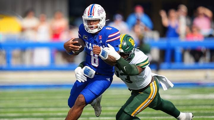 Oct 24, 2026; Lawrence, Kansas, USA; Kansas Jayhawks quarterback Isaiah Marshall (8) runs the ball against Baylor Bears defensive end Garrick Ponder (13) during the first half at David Booth Kansas Memorial Stadium. Mandatory Credit: Jay Biggerstaff-Imagn Images Oct 24, 2026; Lawrence, Kansas, USA; Kansas Jayhawks quarterback Isaiah Marshall (8) runs the ball against Baylor Bears defensive end Garrick Ponder (13) during the first half at David Booth Kansas Memorial Stadium. Mandatory Credit: Jay Biggerstaff-Imagn Images
