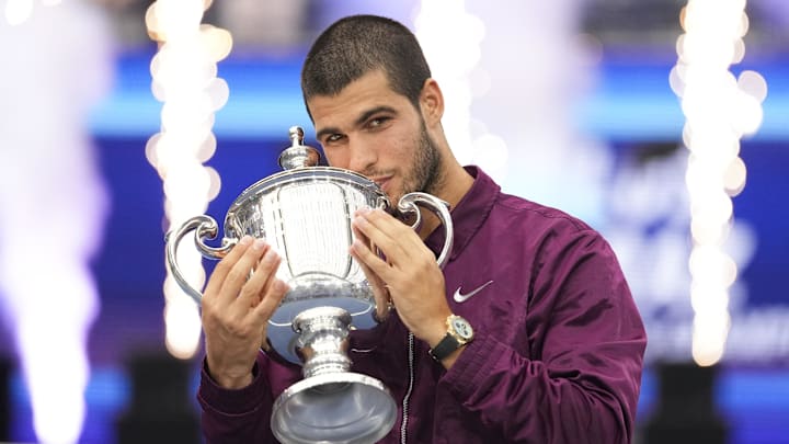 Sep 7, 2025; Flushing, NY, USA; Carlos Alcaraz (ESP) kisses the trophy after defeating Jannik Sinner (ITA) in the 2025 US Open.