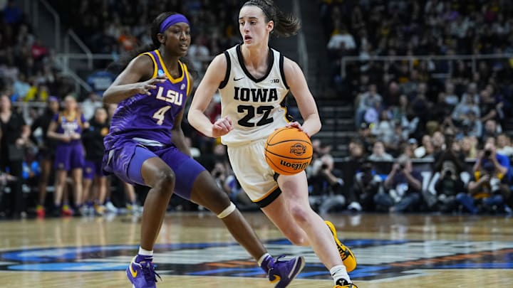 Iowa Hawkeyes guard Caitlin Clark (22) controls the ball against LSU Lady Tigers guard Flau'jae Johnson (4) in the fourth quarter in the finals of the Albany Regional in the 2024 NCAA Tournament.