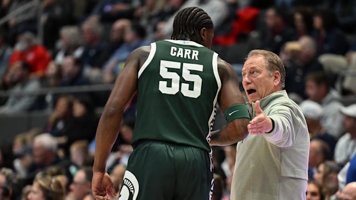Oct 28, 2025; Hartford, CT, USA; Michigan State Spartans head coach Tom Izzo talks with Michigan State Spartans forward Coen Carr (55) during the first half against the Connecticut Huskies at PeoplesBank Arena. Mandatory Credit: Mark Smith-Imagn Images