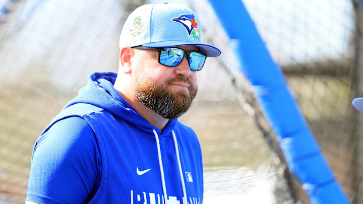 Blue Jays manager John Schneider looks onto the field during spring training practices.