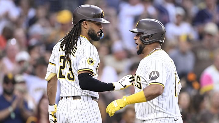 Sep 27, 2025; San Diego, California, USA; San Diego Padres catcher Elias Diaz (17) is congratulated by Fernando Tatis Jr. (23) after hitting a solo home run during the second inning against the Arizona Diamondbacks at Petco Park. Mandatory Credit: Denis Poroy-Imagn Images
