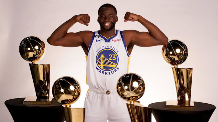 Sep 25, 2022; San Francisco, CA, USA; Golden State Warriors forward Draymond Green (23) poses with the Larry O'Brien Championship Trophies during Media Day at the Chase Center. Mandatory Credit: Cary Edmondson-Imagn Images