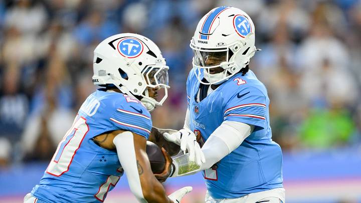 Aug 23, 2026; Nashville, Tennessee, USA;  Tennessee Titans quarterback Cam Ward (1) hands the ball off to running back Tony Pollard (20) against the Seattle Seahawks during the first half at Nissan Stadium. Mandatory Credit: Steve Roberts-Imagn Images