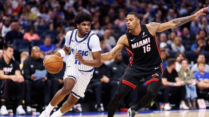 Oct 12, 2025; Orlando, Florida, USA; Orlando Magic guard Jase Richardson (11) drives to the basket while Miami Heat forward Keshad Johnson (16) defends during the second half at Kia Center. Mandatory Credit: Matt Pendleton-Imagn Images