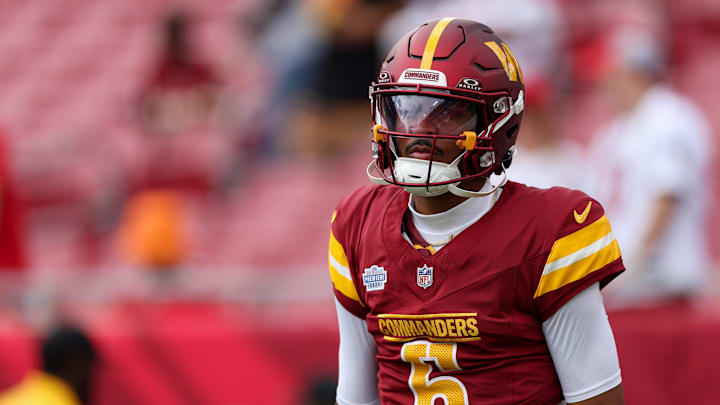Sep 8, 2024; Tampa, Florida, USA; Washington Commanders quarterback Jayden Daniels (5) warms up before a game against the Tampa Bay Buccaneers at Raymond James Stadium. Mandatory Credit: Nathan Ray Seebeck-Imagn Images